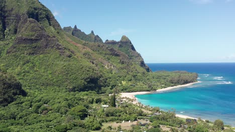 Wide panning aerial shot of the Maniniholo Dry Cave in the small Hawaiian village of Haena on the island of Kaua&#039;i