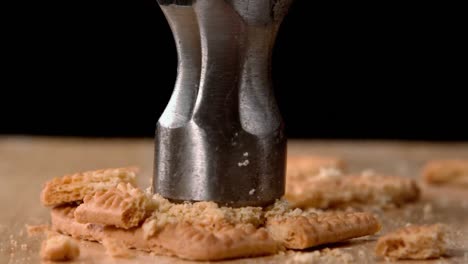 Hammer-smashing-biscuits-on-table