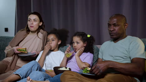 Kids-with-parents-watching-film-at-home