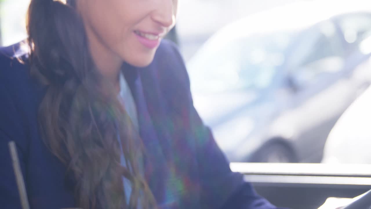 Businesswoman using digital tablet with cup of coffee on table in caf&Atilde;&copy;