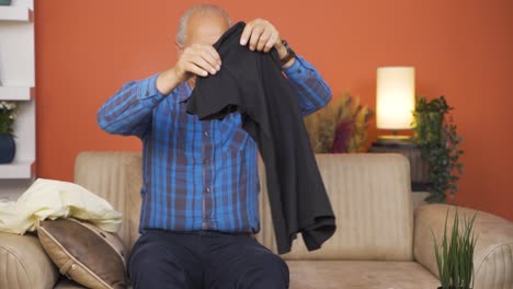 old man preparing bags at home.