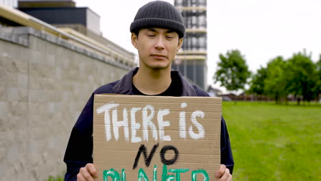 close up of an man holding a placard