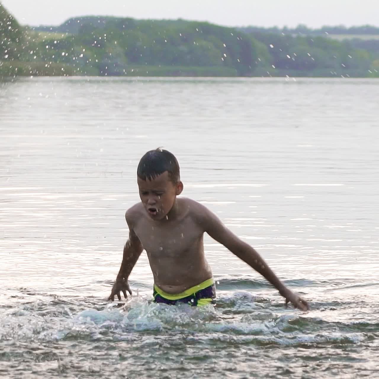 Boy are having fun and splashing in the water. Jumping in the water. Summer holiday concept