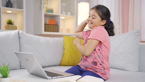 Girl-child-looking-at-laptop-is-happy-and-dancing.