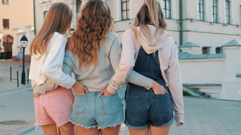 three women friends walking outdoors