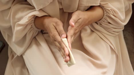 women disinfecting his hands with a wet wipe