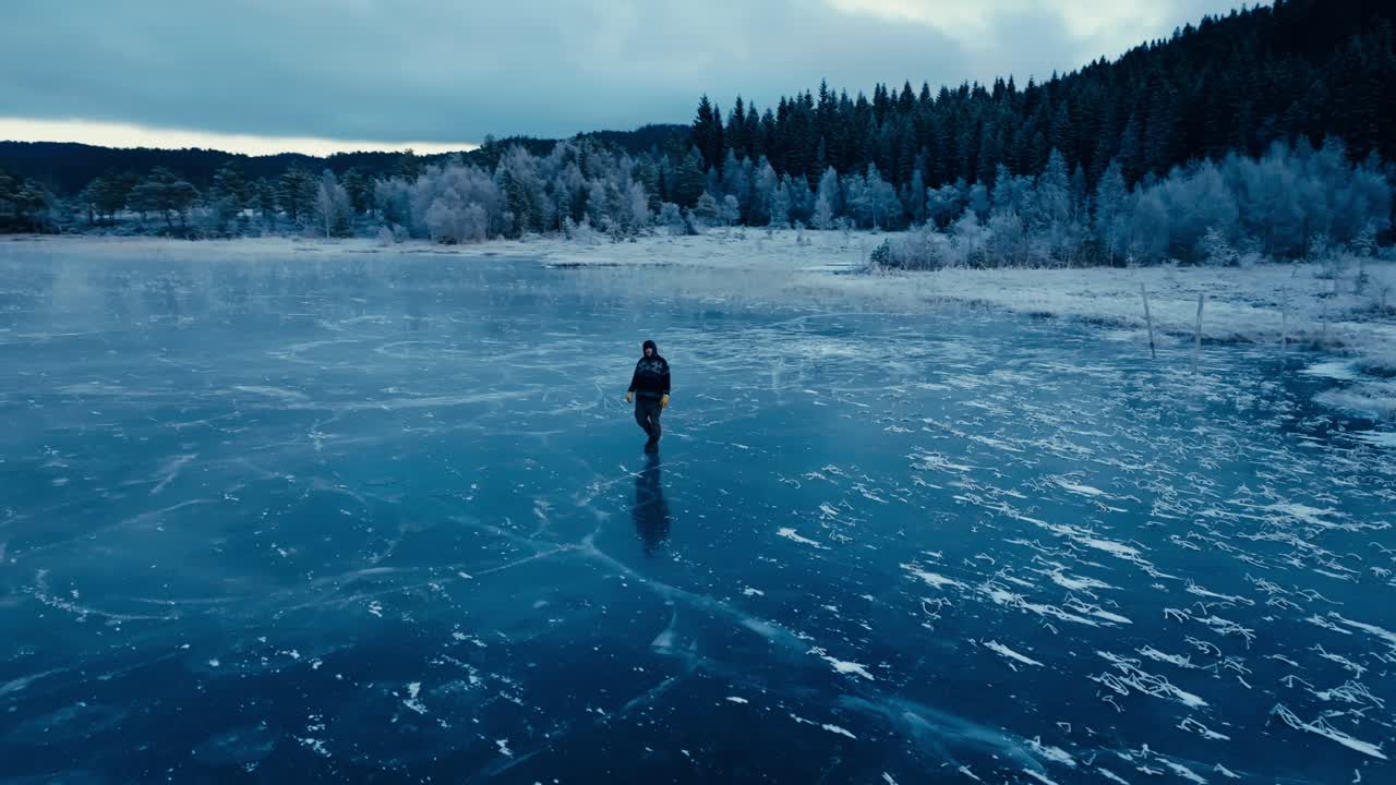 Indre Fosen, Trondelag County, Norway - A Man Strolling Across the Icy Surface of Omundvatnet - Orbit Drone Shot