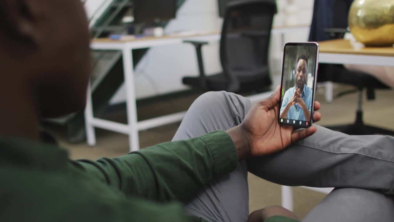 Man taking phone call in business HUD animating dial, readouts rising then falling tracking metrics