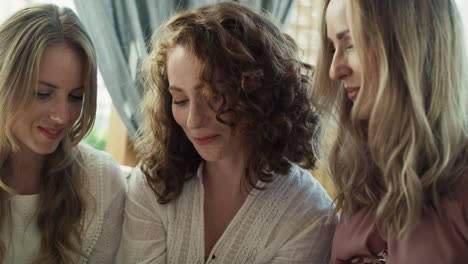 Group-of-female-friends-looking-an-ultrasound-scan-result.