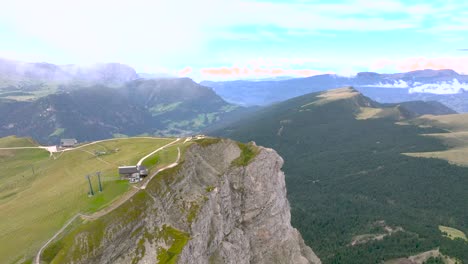 drone flight through the clouds to the end station of a mountain lift in the dolomite mountains