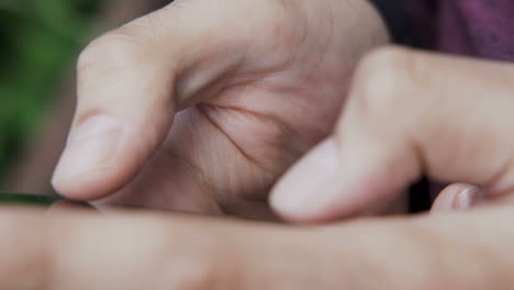 male hands using smartphone and tapping the screen with two fingers, close up