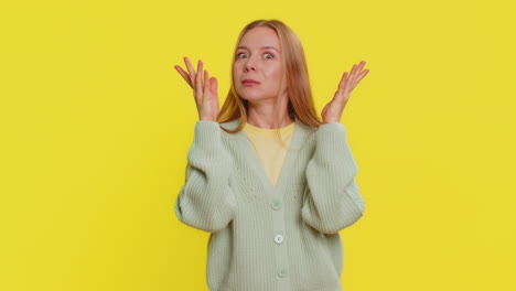 Amazed shocked excited mature woman touching head and showing head explosion looking worried shocked