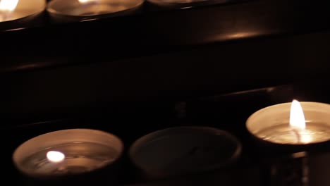 Lighted-candles-in-the-dark-of-the-church