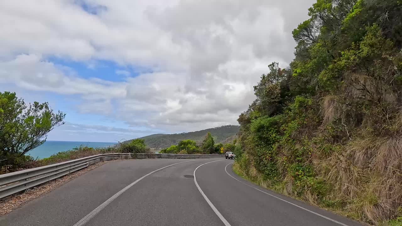 A 15-second video capturing a scenic drive along the winding Great Ocean Road, surrounded by lush greenery and ocean views
