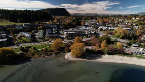 beautiful colours of autumn in wanaka township, lakefront with hotels and restaurants