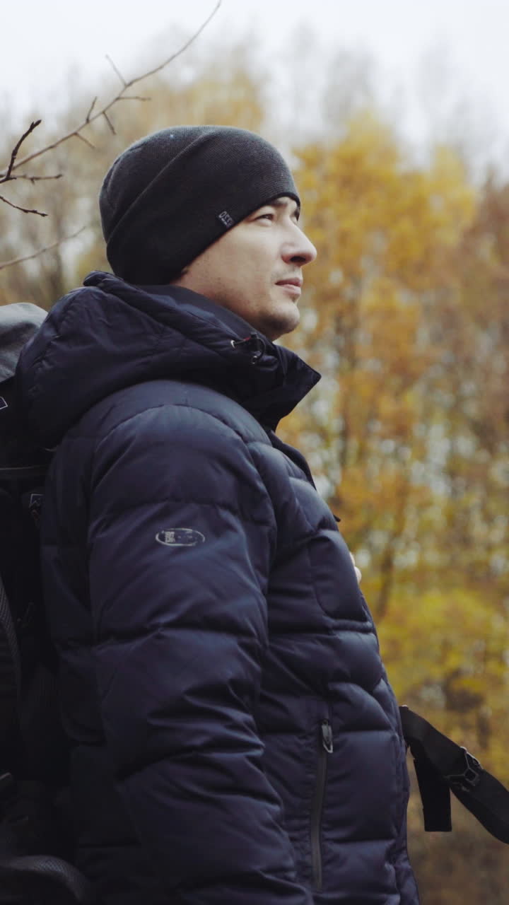 Walking male backpacker tourist. Travel and healthy lifestyle outdoors in fall season nature