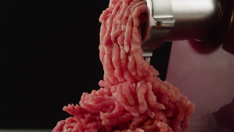 ground meat coming out of a meat grinder