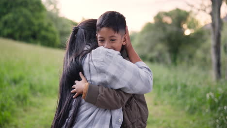 mother and son hugging in a park