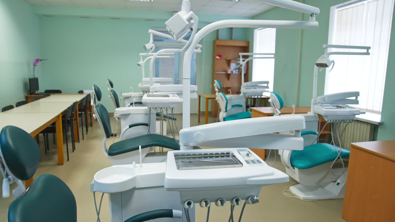 Light classroom for students of dentistry department. Medical school auditory with models of stomatology armchairs.