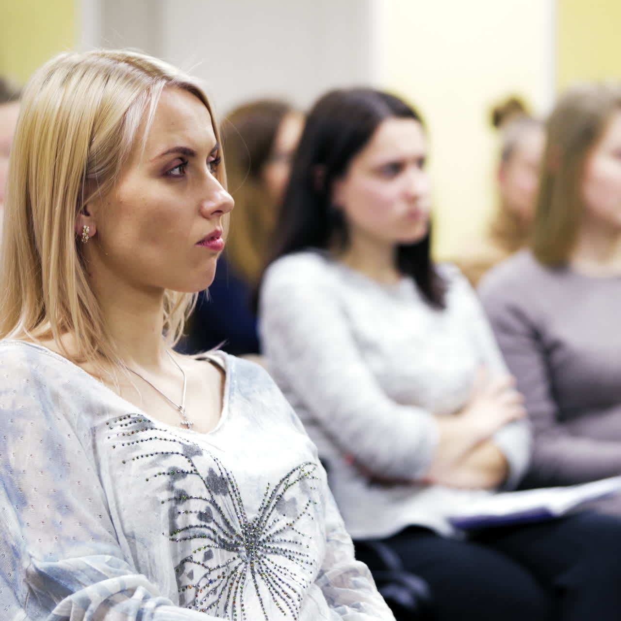 Women audience sitting at congress meeting. Serious audience listen to interesting discussion at business forum in the conference hall.