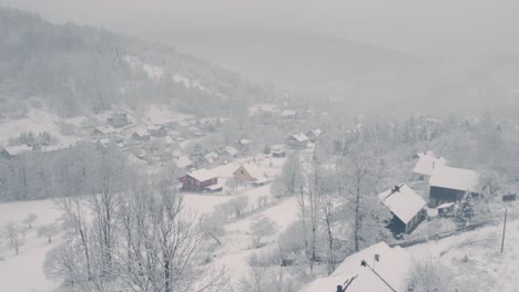 aerial landscape of countryside covered by fog and snow in winter morning