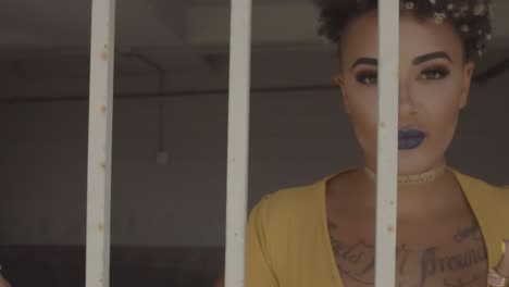 young adult millennial woman blond afro dressed up in solar yellow dress full makeup and nails locked in a cell