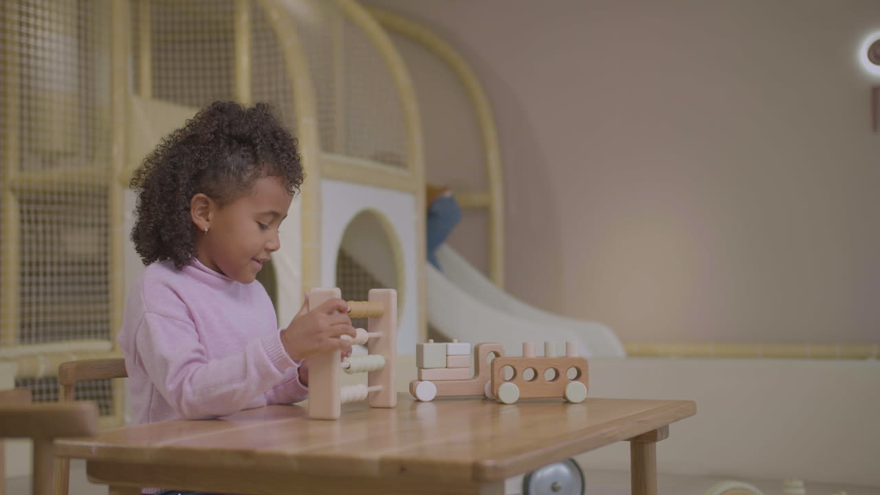 Little girl counting in playroom