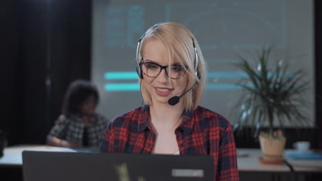 woman working in a call center with a headset and laptop