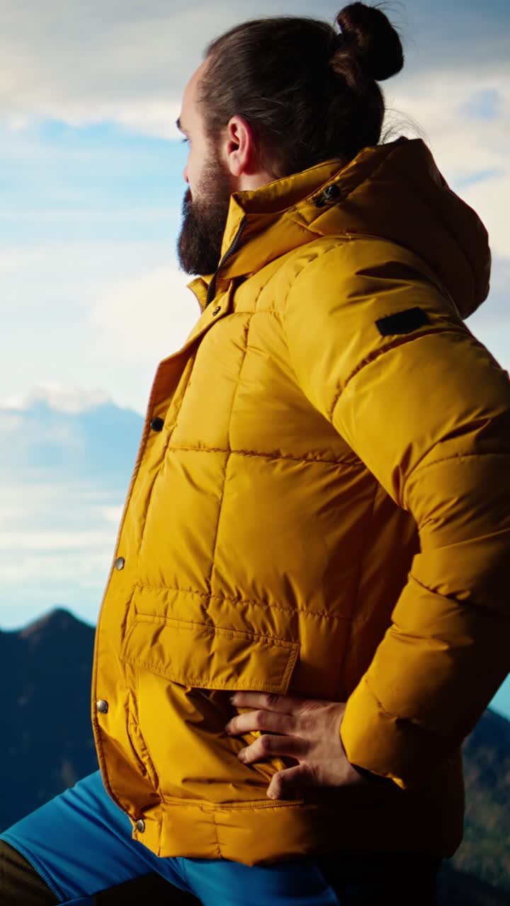 Man in Yellow Puffer Jacket Looking at Mountain View