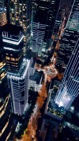 modern city at night: high-rise buildings and streaking lights