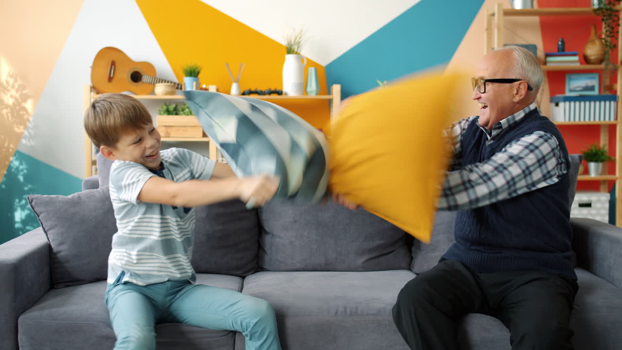 Grandparent and Grandchild Having a Pillow Fight