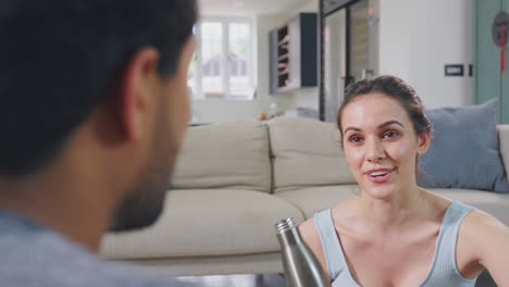 Couple-at-home-chatting-after-exercising-at-home-together---shot-in-slow-motion