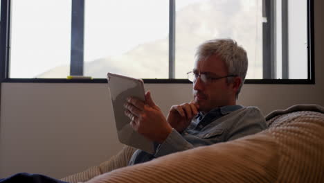 caucasian man using computer tablet in creative office