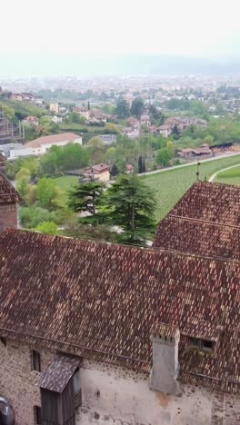 well preserved medieval fortress on hillside next to big city, historic cultural architectural masterpiece