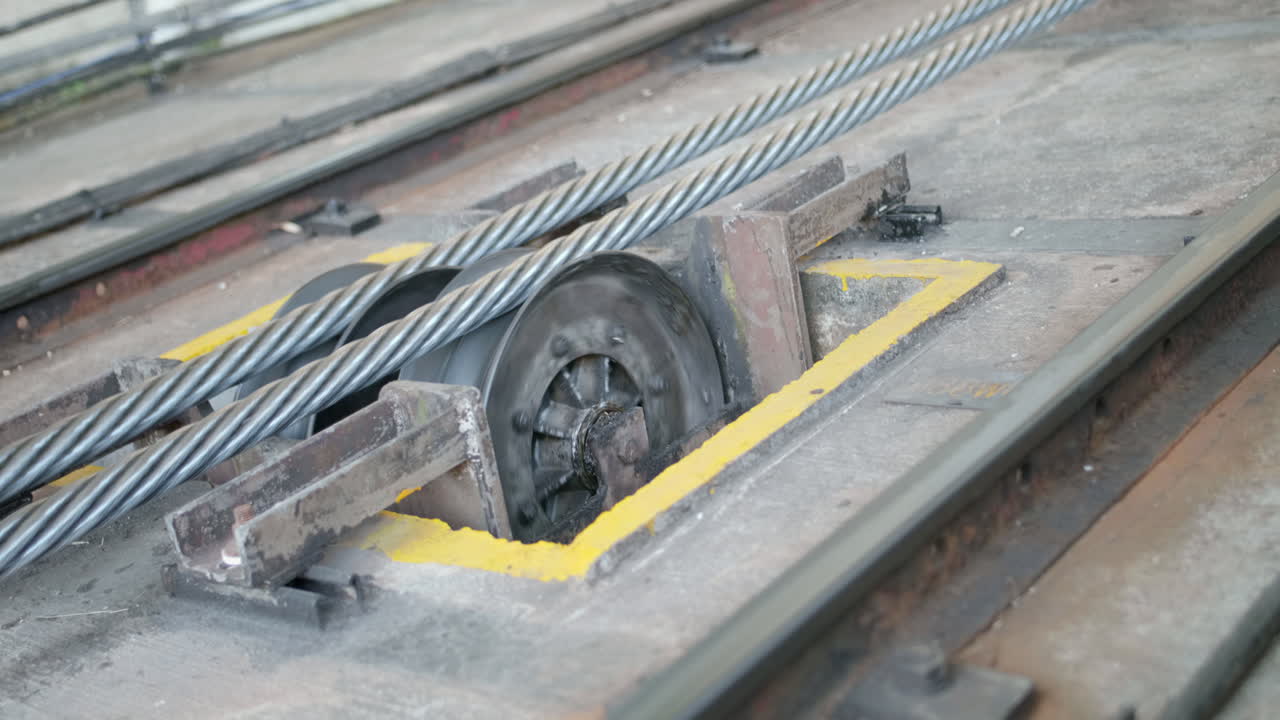 Close up of a functioning working cable-car mechanism that stops spinning at the end of the shot. The Peak Tram funicular railway going to the Peak Tower, Hong Kong,