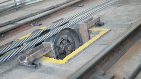 close up of a functioning working cable-car mechanism that stops spinning at the end of the shot. the peak tram funicular railway going to the peak tower, hong kong,