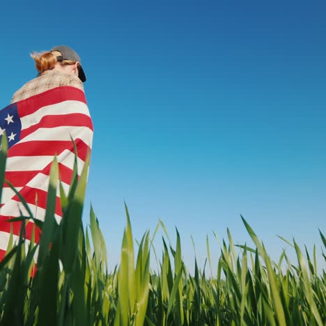 a woman with a us flag in a meadow