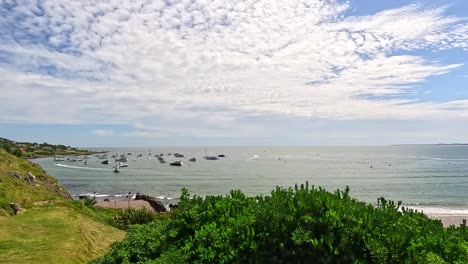 view of the punta ballena bay, showing yachts and people enjoying the beach, uruguay