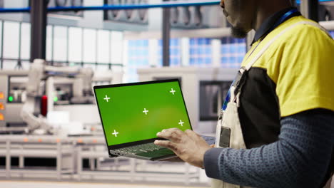 vertical video smart factory mechanic testing automated systems using isolated screen laptop