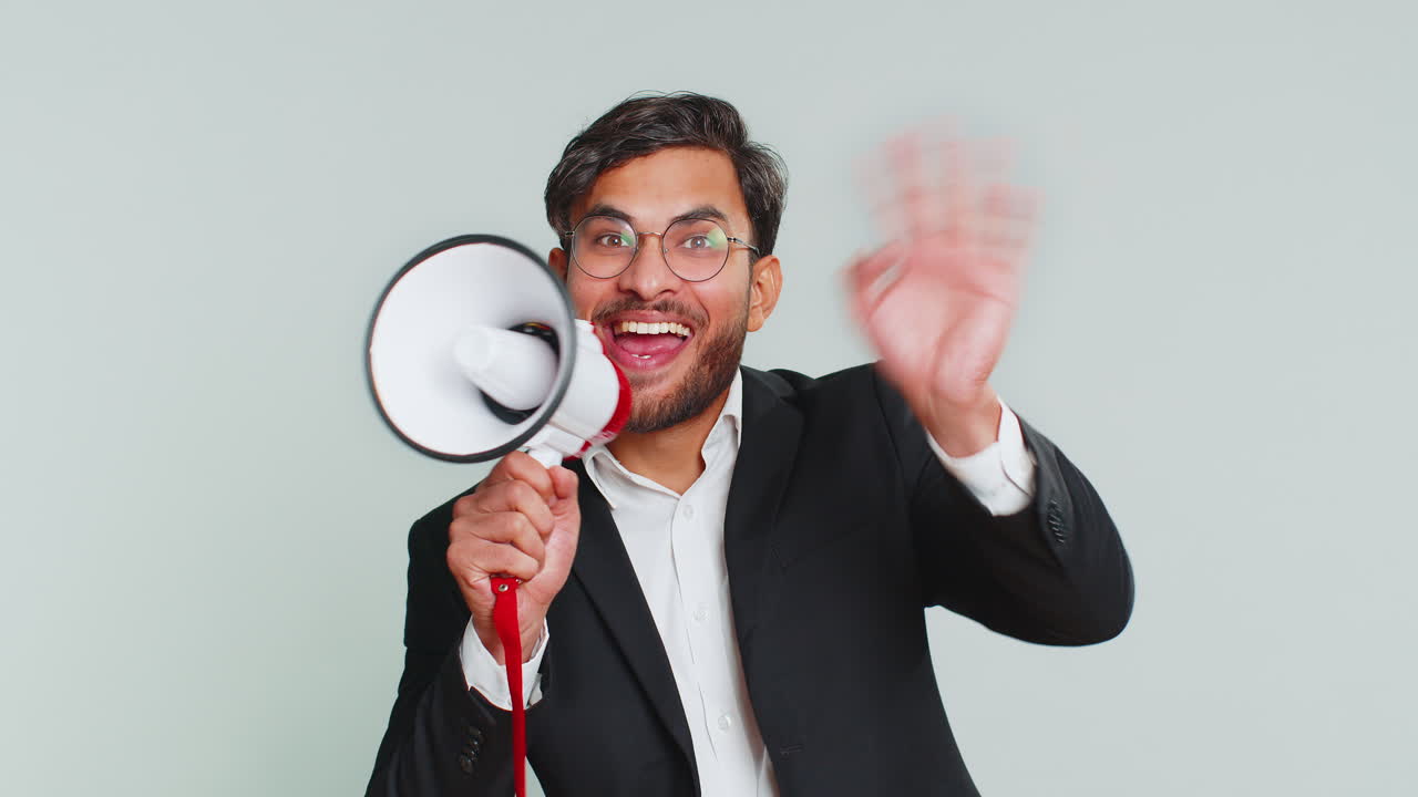 Indian man talking with megaphone proclaiming news loudly announcing advertisement discounts sale
