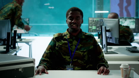 army personnel in a high tech command center attends a videocall meeting