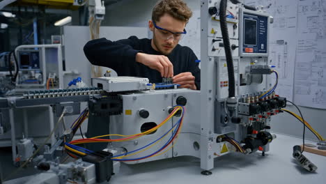engineer assembling electronic machinery in a lab