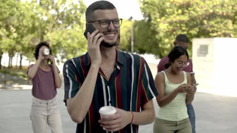 smiling handsome bearded man talking on smartphone.