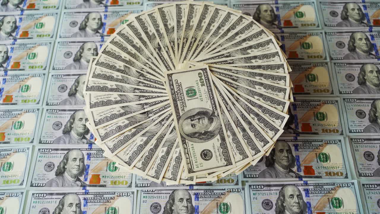 Background of american money. Rotation of one hundred dollar money bills. 100 dollar banknotes spin around on the beautiful background of cash.