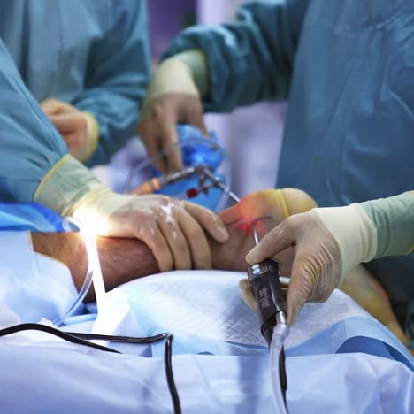 modern hospital emergency department. team of surgeons performing delicate operation using medical surgical equipment