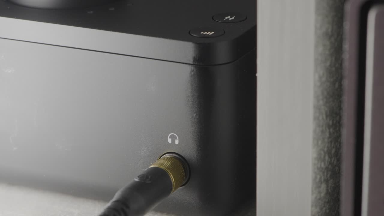 Close-up view of a digital audio player with controls and connections.