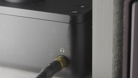 close-up view of a digital audio player with controls and connections.