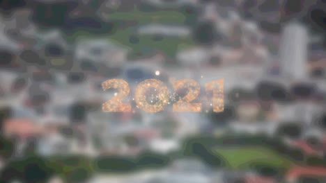 2021 text over fireworks bursting against aerial view of cityscape