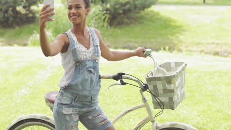 cheerful woman taking selfie in park