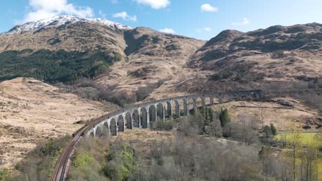 cinematic establishing shot of glenfinnan viaduct on beautiful day